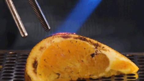 Real-Orange Bartender making great cocktails by roasting an orange.